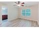 Bedroom features hard surface floors, neutral paint, ceiling fan, and large window at 3453 Dianthus Ln, Lawrenceville, GA 30044