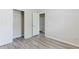 Bedroom with light gray plank flooring, closet, and an open doorway to another room at 3453 Dianthus Ln, Lawrenceville, GA 30044