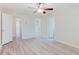 Spacious bedroom with light gray plank flooring, ceiling fan, and access to a closet at 3453 Dianthus Ln, Lawrenceville, GA 30044