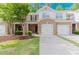 Charming brick townhome with a well-manicured lawn and a two-car garage, creating an inviting curb appeal at 3453 Dianthus Ln, Lawrenceville, GA 30044