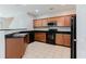 The kitchen features granite counters, wooden cabinets, tile backsplash, and black appliances at 3453 Dianthus Ln, Lawrenceville, GA 30044