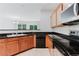 This kitchen features granite counters, wooden cabinets, tile backsplash, and stainless steel appliances at 3453 Dianthus Ln, Lawrenceville, GA 30044
