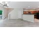 Open concept living space next to kitchen with hard surface floors and neutral paint at 3453 Dianthus Ln, Lawrenceville, GA 30044