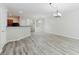Open concept living space next to kitchen with hard surface floors and neutral paint at 3453 Dianthus Ln, Lawrenceville, GA 30044