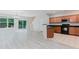 Bright open-concept living area with modern flooring, a sliding glass door, and a stylish kitchen in view at 3453 Dianthus Ln, Lawrenceville, GA 30044