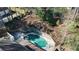 Overhead view of the backyard pool, retaining wall, and surrounding trees providing seclusion at 6300 Mountain Brook Ln, Atlanta, GA 30328