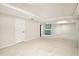 Spacious finished basement with neutral carpet and a pop of color from a small, blue cabinet at 6300 Mountain Brook Ln, Atlanta, GA 30328