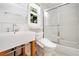 Bright bathroom with a floating vanity, elongated toilet and a shower/tub combination at 6300 Mountain Brook Ln, Atlanta, GA 30328
