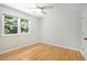 Bright bedroom with hardwood floors and a window offering a view of lush greenery at 6300 Mountain Brook Ln, Atlanta, GA 30328