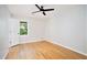 Neutral bedroom featuring hardwood floors, a ceiling fan, and a window offering natural light at 6300 Mountain Brook Ln, Atlanta, GA 30328