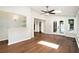 Large bonus room with hardwood floors, natural light, ceiling fan, and backyard access through glass doors at 6300 Mountain Brook Ln, Atlanta, GA 30328