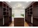 Walk-in closet with custom shelving and center island at 6300 Mountain Brook Ln, Atlanta, GA 30328