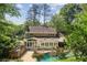 Aerial view of a house with a screened-in porch and swimming pool at 6300 Mountain Brook Ln, Atlanta, GA 30328
