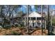 Classic two-story brick home with white columns and a symmetrical facade surrounded by mature trees and landscaping at 6300 Mountain Brook Ln, Atlanta, GA 30328