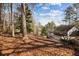 Exterior view of a house from wooded lot with a screened-in porch at 6300 Mountain Brook Ln, Atlanta, GA 30328