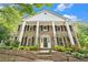 Elegant brick home with stately white columns and a beautifully landscaped front yard creates a welcoming entrance at 6300 Mountain Brook Ln, Atlanta, GA 30328