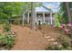 Charming two-story home with stone facade, white columns, and a beautifully landscaped front yard at 6300 Mountain Brook Ln, Atlanta, GA 30328