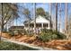 Two-story brick home featuring a landscaped yard and driveway, surrounded by mature trees at 6300 Mountain Brook Ln, Atlanta, GA 30328