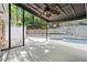 Covered patio with fan overlooking a pool, white fence, and privacy wall offers a relaxing outdoor space at 6300 Mountain Brook Ln, Atlanta, GA 30328