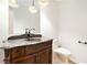 Quaint powder room with an antique vanity and a marble countertop at 6300 Mountain Brook Ln, Atlanta, GA 30328