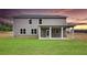 Spacious backyard featuring a covered patio, perfect for outdoor relaxation and entertaining with ample space for recreation at 133 Canal St, Hampton, GA 30228