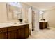 Bathroom featuring double sinks with dark wood cabinets, white countertops and neutral tile floors at 133 Canal St, Hampton, GA 30228