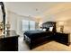 Bedroom featuring a dark bed, dark dresser, dark nightstand, and a window with blinds at 133 Canal St, Hampton, GA 30228