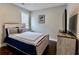 Cozy bedroom features a comfortable bed, dark hardwood floors, and neutral paint at 133 Canal St, Hampton, GA 30228