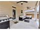 Covered patio with ceiling fans, an outdoor seating area, and a grill at 133 Canal St, Hampton, GA 30228