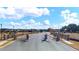 Community entrance showcases a paved road leading into the neighborhood with manicured lawns and attractive homes at 133 Canal St, Hampton, GA 30228