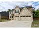 Attractive brick home boasts a two-car garage and lush green lawn at 133 Canal St, Hampton, GA 30228