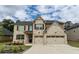 Inviting brick home featuring a two-car garage and well-maintained landscaping at 133 Canal St, Hampton, GA 30228