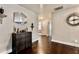 Hallway featuring hardwood floors, decorative wall art, and access to other rooms at 133 Canal St, Hampton, GA 30228
