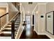 Bright hallway features hardwood floors, staircase, elegant decor, and access to other rooms in the house at 133 Canal St, Hampton, GA 30228