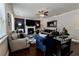 Comfortable living room with a fireplace, hardwood floors, and elegant decor, perfect for gatherings at 133 Canal St, Hampton, GA 30228