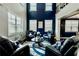 Elegant living room with a soaring ceiling, plenty of natural light, and a dark blue accent wall at 133 Canal St, Hampton, GA 30228
