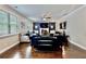 Bright and airy living room with large windows, hardwood floors, and stylish furnishings, perfect for relaxation at 133 Canal St, Hampton, GA 30228