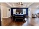 Luxurious main bedroom with tray ceiling, dark wood floors, and stylish furnishings at 133 Canal St, Hampton, GA 30228