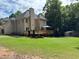 Well-manicured backyard features a large wooden deck, a gazebo, green grass and a storage shed at 1502 La Fayette Pl, Loganville, GA 30052