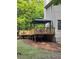 Elevated wood deck with a gazebo, overlooking a serene backyard at 1502 La Fayette Pl, Loganville, GA 30052