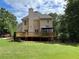 Spacious backyard featuring a well-kept lawn, a wooden deck, and a gazebo at 1502 La Fayette Pl, Loganville, GA 30052