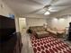 Comfortable basement showcasing a red patterned rug, neutral couches, and recessed lighting at 1502 La Fayette Pl, Loganville, GA 30052