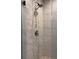 Modern bathroom shower with decorative stone accents and updated fixture at 1502 La Fayette Pl, Loganville, GA 30052