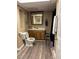 Traditional bathroom featuring wood cabinets, updated fixtures, and neutral wall paint at 1502 La Fayette Pl, Loganville, GA 30052