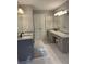 Large primary bathroom with double sink vanity, granite countertop and tiled floor at 1502 La Fayette Pl, Loganville, GA 30052