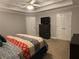 Comfortable bedroom featuring tray ceiling, wall-mounted TV, and a neutral color palette at 1502 La Fayette Pl, Loganville, GA 30052