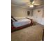 Well-lit bedroom with a bed, neutral colors, and a ceiling fan at 1502 La Fayette Pl, Loganville, GA 30052