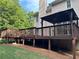 Stained wood deck featuring a gazebo, with green lawn and trees at 1502 La Fayette Pl, Loganville, GA 30052