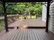 Wood deck featuring dark stain with a grill and outdoor bench, surrounded by leafy trees at 1502 La Fayette Pl, Loganville, GA 30052