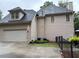 Side view of a two-story home with a 2-car garage and landscaped yard at 1502 La Fayette Pl, Loganville, GA 30052